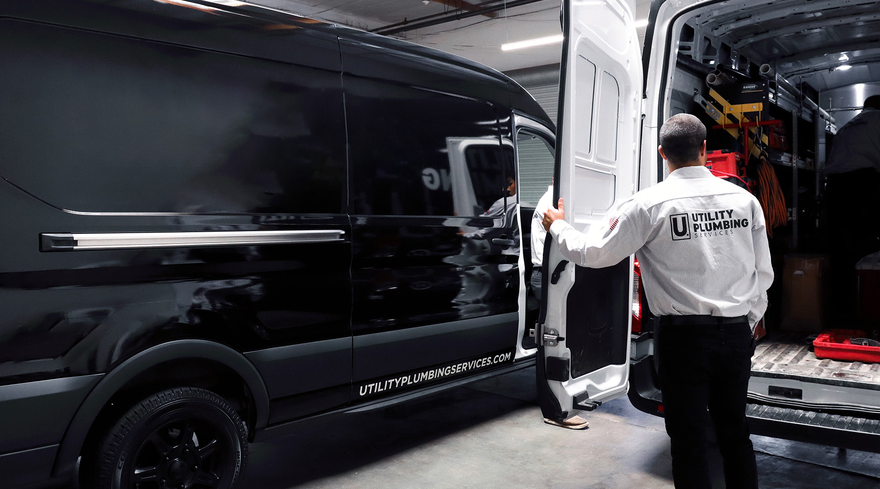 Utility plumber closing work van door