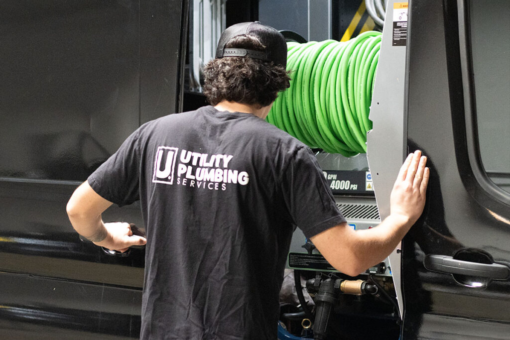 The Risks of Hydro Jetting: What Every Homeowner Should Know 5 Utility plumber closing work van with hydro jetting equipment inside