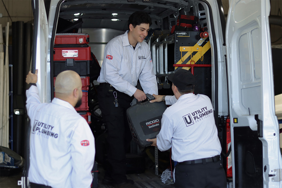 The Risks of Hydro Jetting: What Every Homeowner Should Know 3 Utility plumbers holding SeeSnake camera