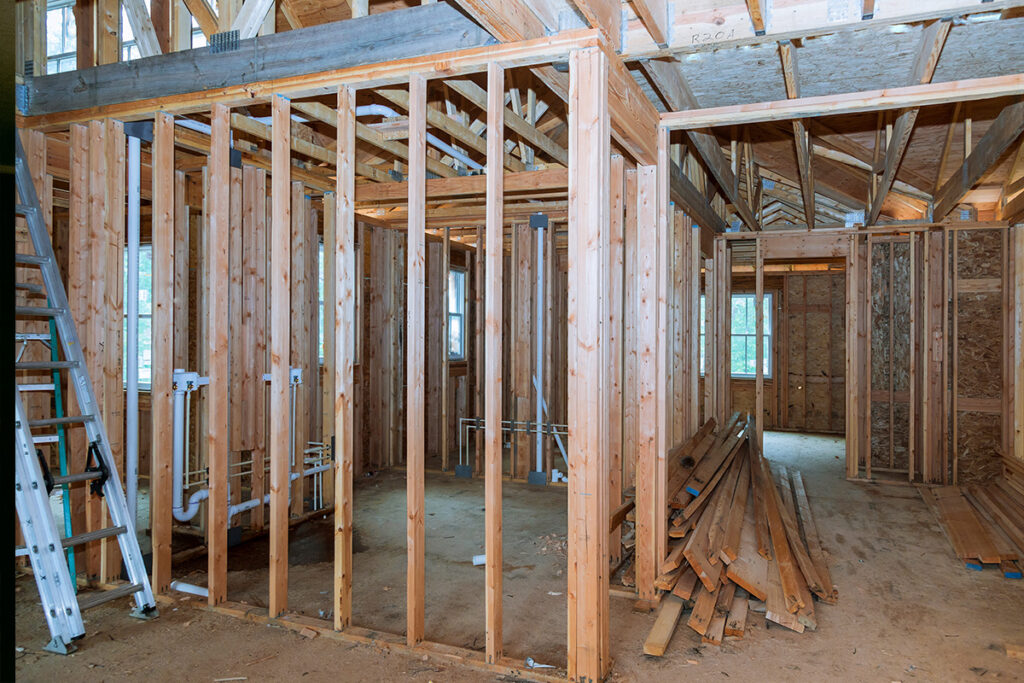 10 Tips to Improve Your Home in Rancho Cucamonga 8 Building structure with wooden frames and materials stacked on the floor.
