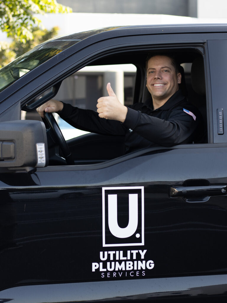 utility plumbing services cody thumbs up in work truck
